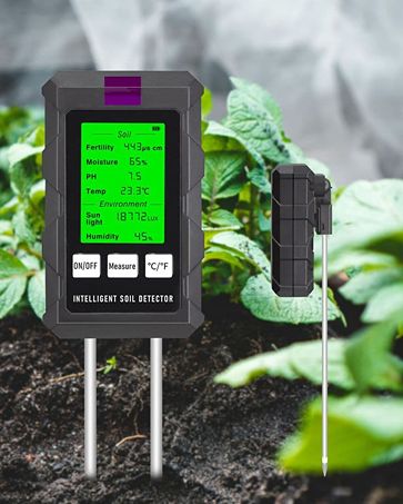 Intelligent soil detector in a garden setting with plants in the background
